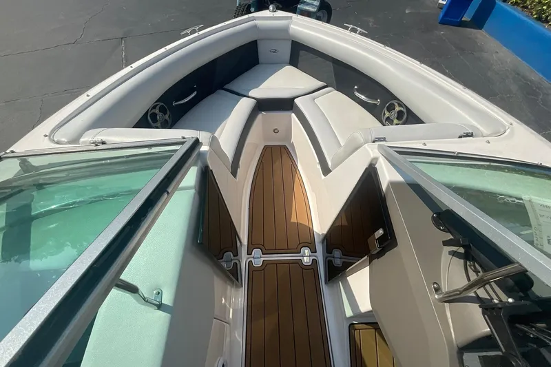 Slide: The Image of 2015 Regal 2100 Bowrider interior with sleek seating and wood-style flooring. - 14