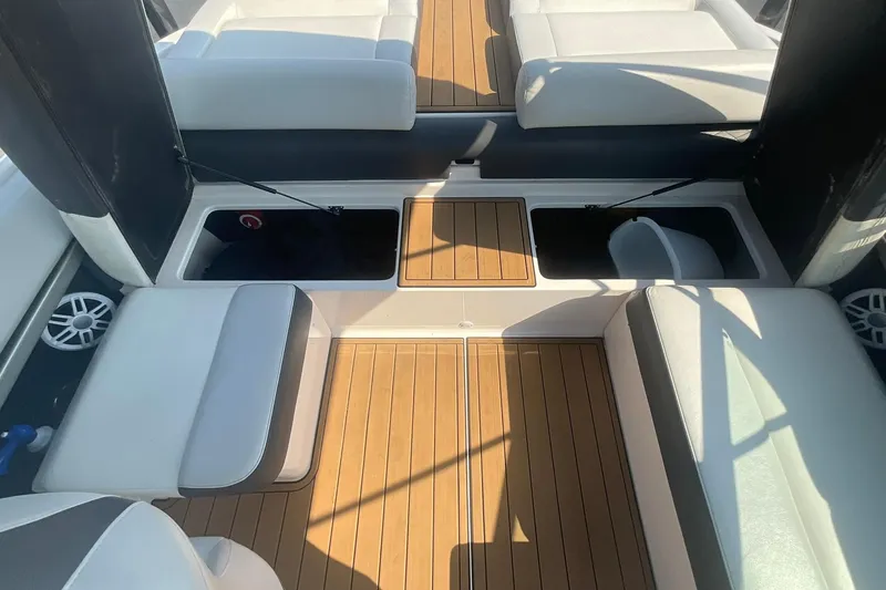 Slide: The Image of 2015 Regal 2100 Bowrider interior with teak flooring and white seating. - 15