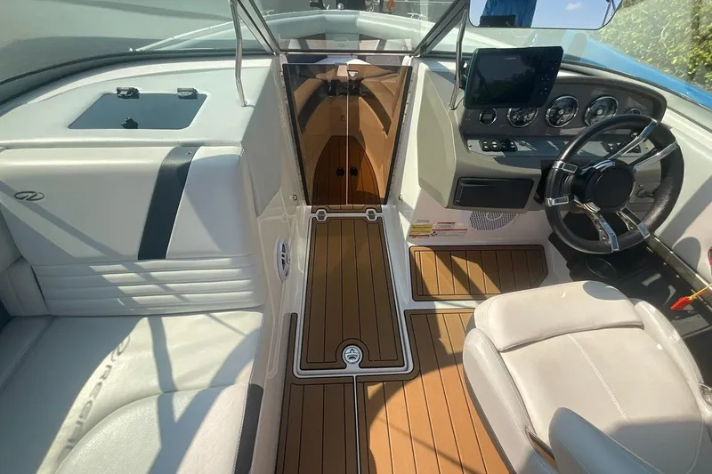 Slide: The Image of 2015 Regal 2100 Bowrider interior with sleek dashboard and comfortable seating. - 18