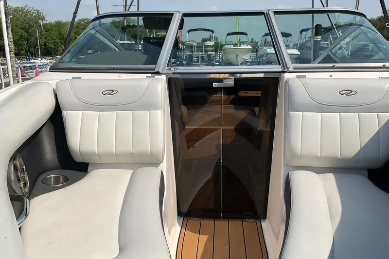 Slide: The Image of 2015 Regal 2100 Bowrider interior with white seating and wooden flooring. - 21