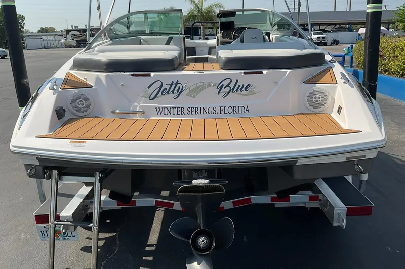 Slide: The Image of 2015 Regal 2100 Bowrider boat, named "Jetty Blue," docked in Winter Springs, Florida. - 5