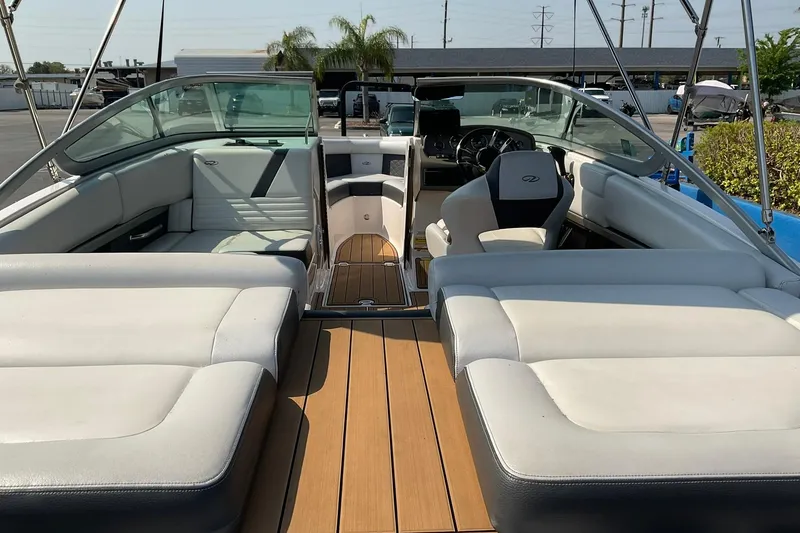 Slide: The Image of 2015 Regal 2100 Bowrider boat interior with spacious seating and sleek design. - 7