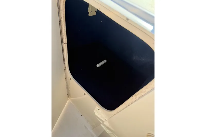 Slide: The Image of Storage compartment inside a 2001 Sea Ray 210 Bow Rider boat. - 12