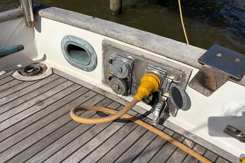 Slide: The Image of 1986 Grand Banks 42 Classic boat deck with power connections and wooden flooring. - 11
