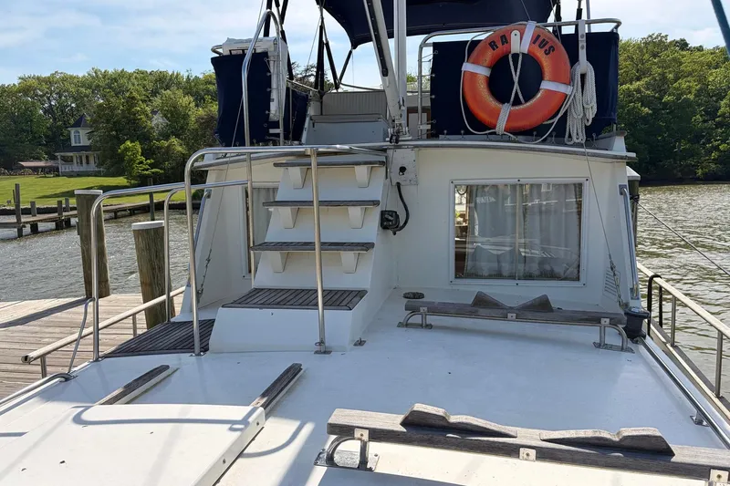 Slide: The Image of 1986 Grand Banks 42 Classic yacht docked, featuring upper deck access and lifebuoy. - 12