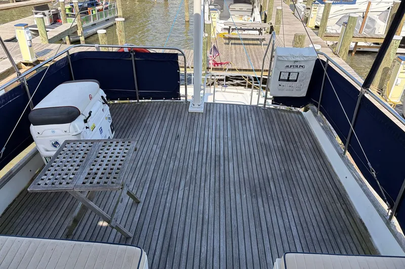 Slide: The Image of Aft deck of 1986 Grand Banks 42 Classic yacht with wooden flooring and seating. - 16