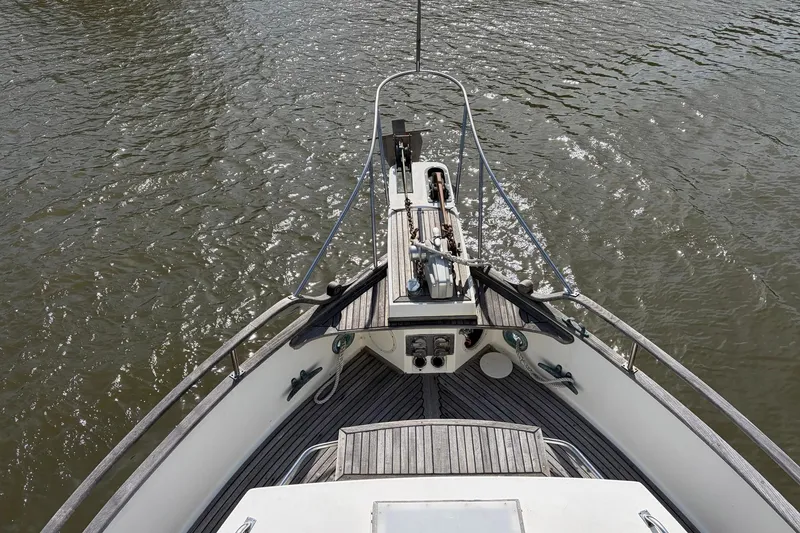 Slide: The Image of Bow view of 1986 Grand Banks 42 Classic yacht on water. - 17