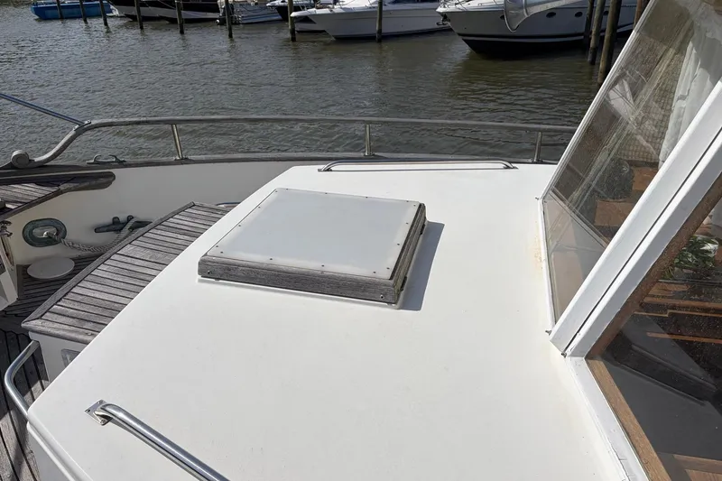Slide: The Image of 1986 Grand Banks 42 Classic yacht deck with hatch, docked near other boats. - 20