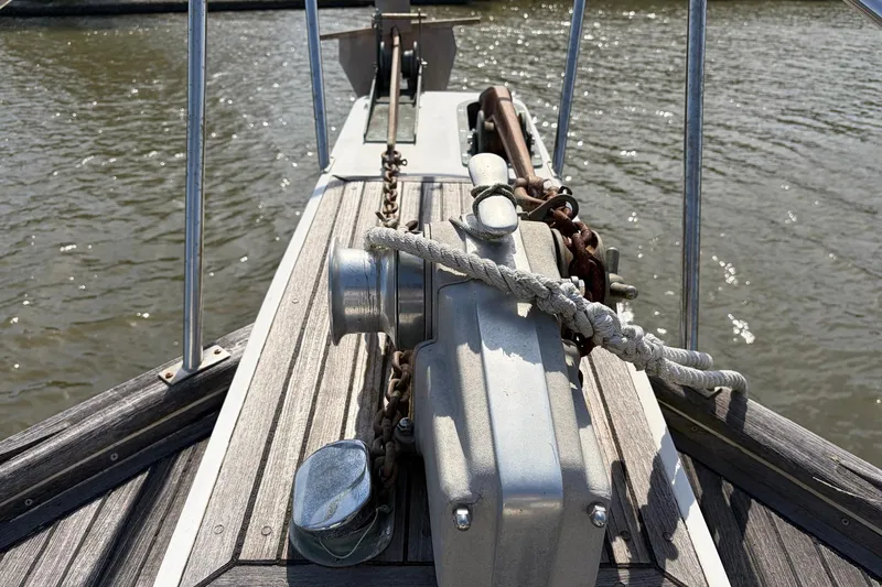 Slide: The Image of Bow of 1986 Grand Banks 42 Classic yacht with anchor chain and winch. - 22