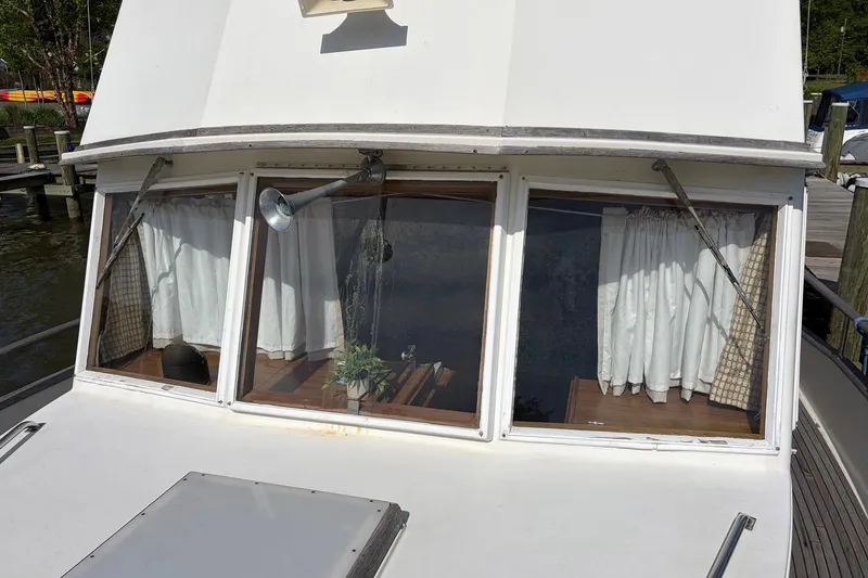 Slide: The Image of 1986 Grand Banks 42 Classic yacht with curtained windows and deck view. - 23