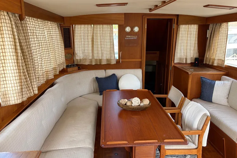 Slide: The Image of Interior of a 1986 Grand Banks 42 Classic yacht with wood furnishings and cozy seating. - 24