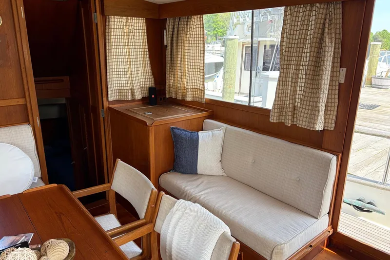 Slide: The Image of Interior of 1986 Grand Banks 42 Classic yacht with cozy seating and wooden accents. - 25