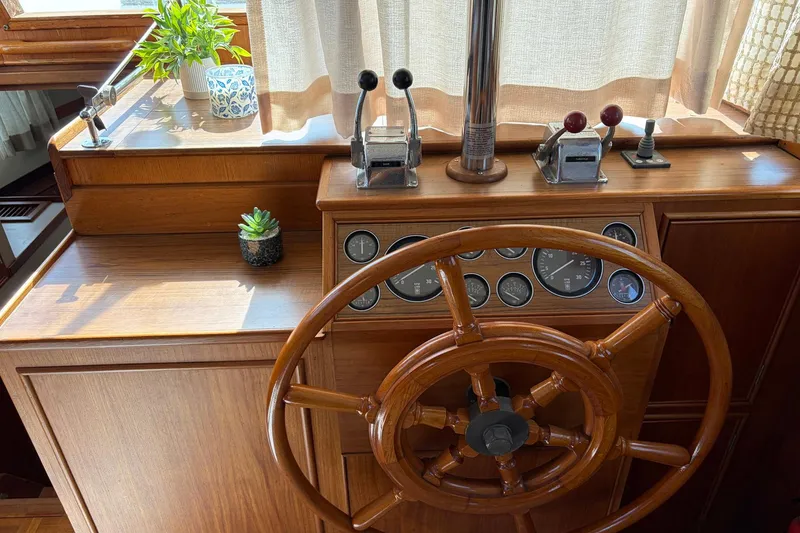 Slide: The Image of Helm of 1986 Grand Banks 42 Classic yacht with wooden wheel and control panel. - 27
