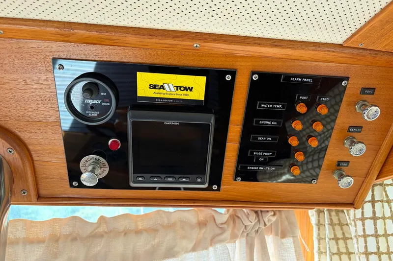 Slide: The Image of Control panel of a 1986 Grand Banks 42 Classic boat with navigation and alarm systems. - 28