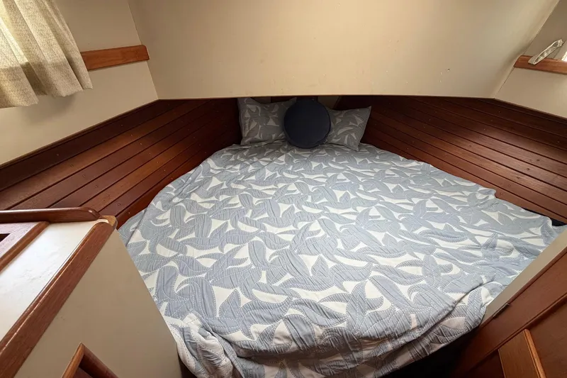 Slide: The Image of Cozy cabin bed in 1986 Grand Banks 42 Classic yacht with patterned bedding. - 31