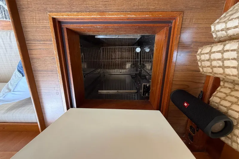 Slide: The Image of Interior of a 1986 Grand Banks 42 Classic yacht, featuring a built-in appliance. - 34