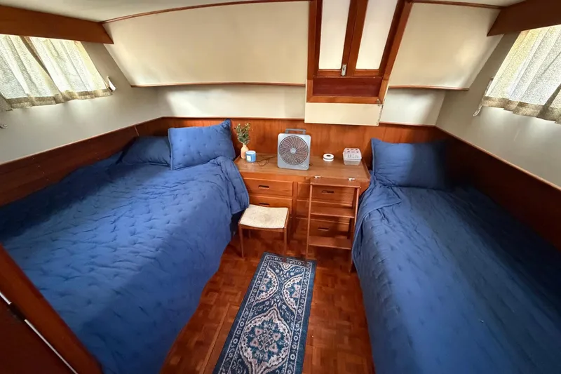 Slide: The Image of Cabin interior of 1986 Grand Banks 42 Classic with twin beds and wooden furnishings. - 36