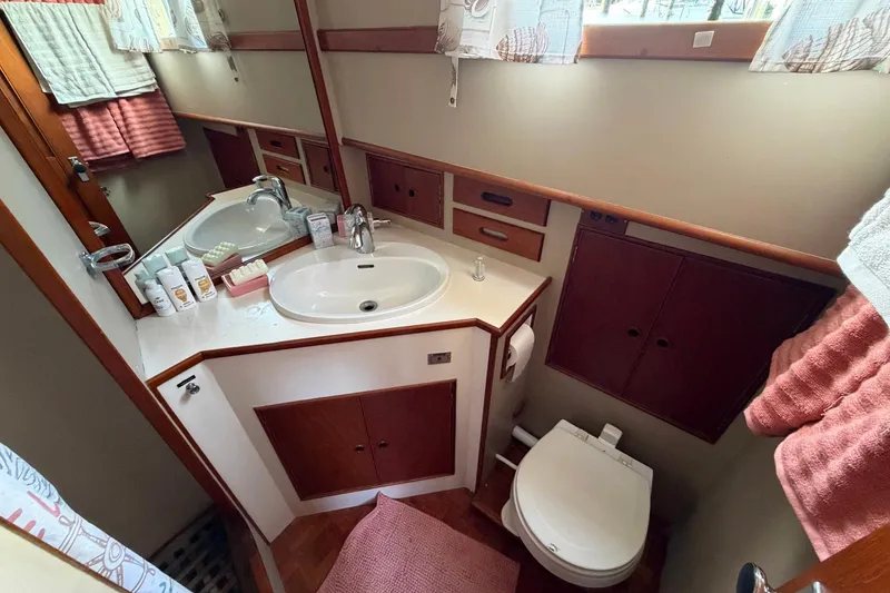 Slide: The Image of Bathroom interior of 1986 Grand Banks 42 Classic yacht, featuring sink, mirror, and toilet. - 38