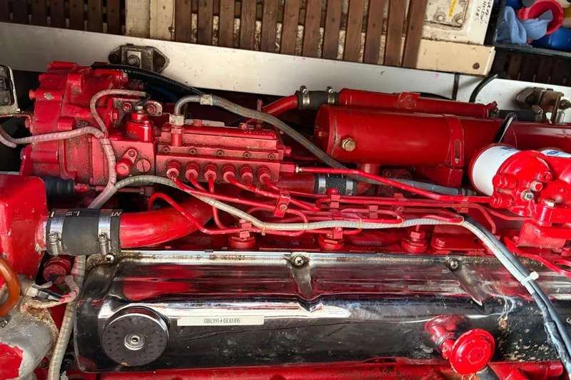 Slide: The Image of Engine of a 1986 Grand Banks 42 Classic boat, featuring red components and intricate wiring. - 42