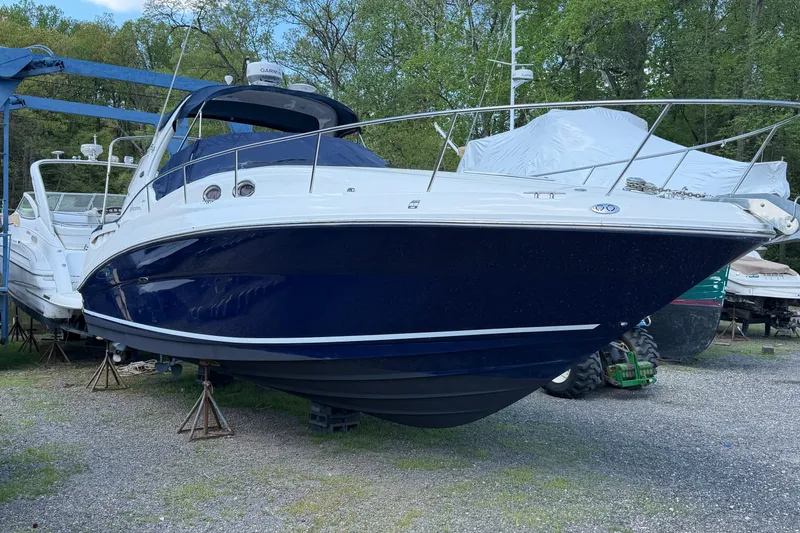 Slide: The Image of 2005 Sea Ray Sundancer 320 boat on stands, surrounded by trees and other boats. - 15