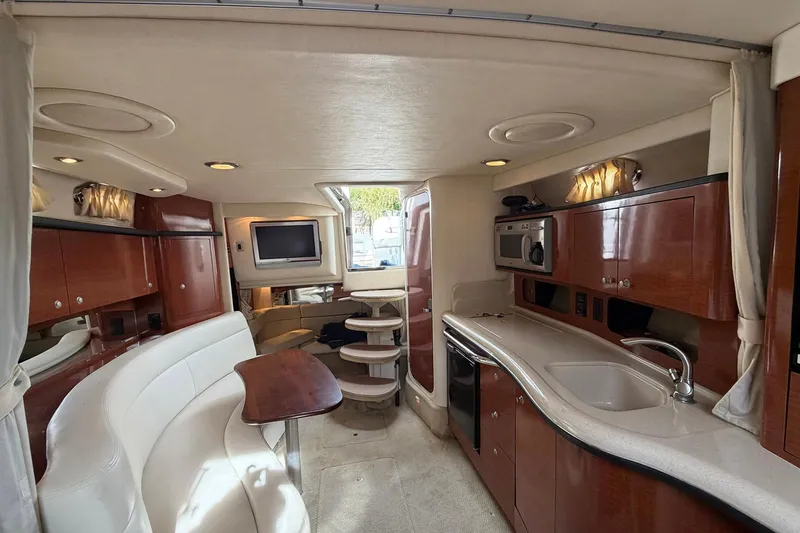 Slide: The Image of Luxurious interior of 2005 Sea Ray 320 Sundancer yacht with kitchen and seating area. - 2