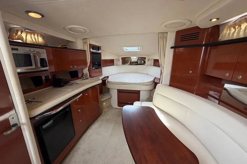 Slide: The Image of Luxurious interior of 2005 Sea Ray 320 Sundancer yacht with kitchenette and seating area. - 4