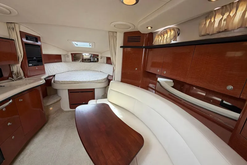 Slide: The Image of Luxurious interior of 2005 Sea Ray 320 Sundancer yacht with elegant wood finishes and cozy seating. - 5