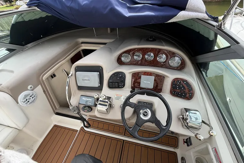 Slide: The Image of 2005 Sea Ray 320 Sundancer helm with Garmin and Raymarine navigation systems. - 8