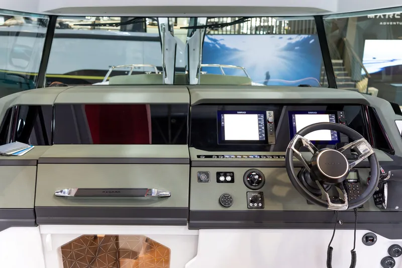 Slide: The Image of 2026 Axopar 38 Cross Cabin helm with modern controls and dual displays. - 13