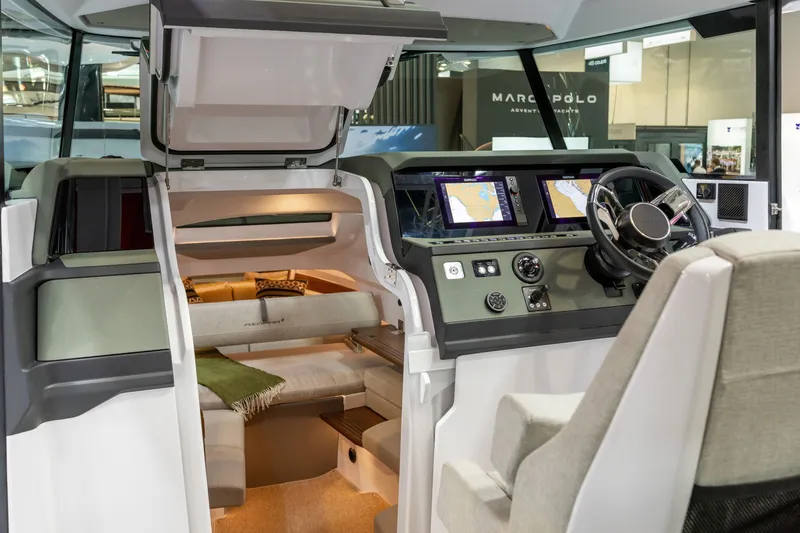 Slide: The Image of 2026 Axopar 38 Cross Cabin interior with navigation screens and seating area. - 18