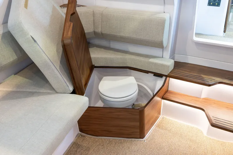 Slide: The Image of 2026 Axopar 38 Cross Cabin interior with hidden toilet under wooden seat. - 20