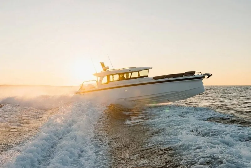 Slide: The Image of 2026 Axopar 38 Cross Cabin boat cruising at sunset on open water. - 4