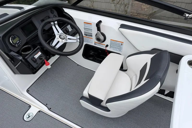 Slide: The Image of 2019 Yamaha Boats SX195 cockpit with steering wheel and captain's seat. - 10
