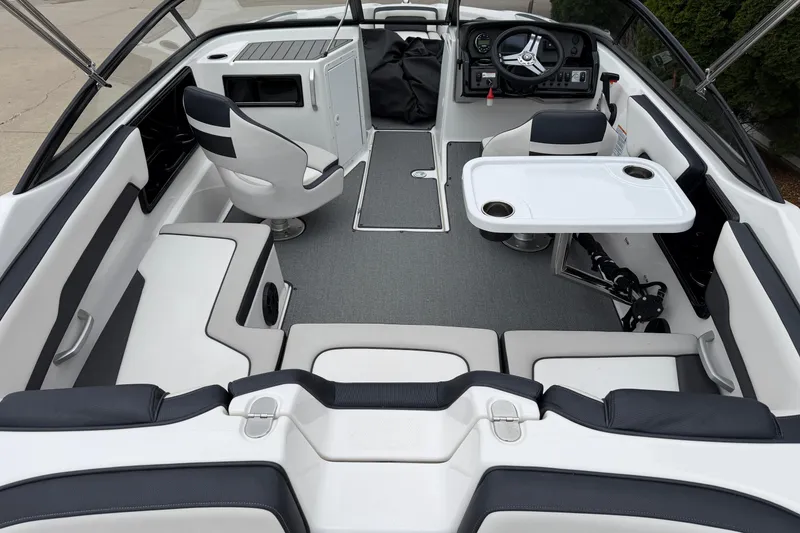 Slide: The Image of 2019 Yamaha Boats SX195 interior with seating, steering wheel, and table setup. - 12