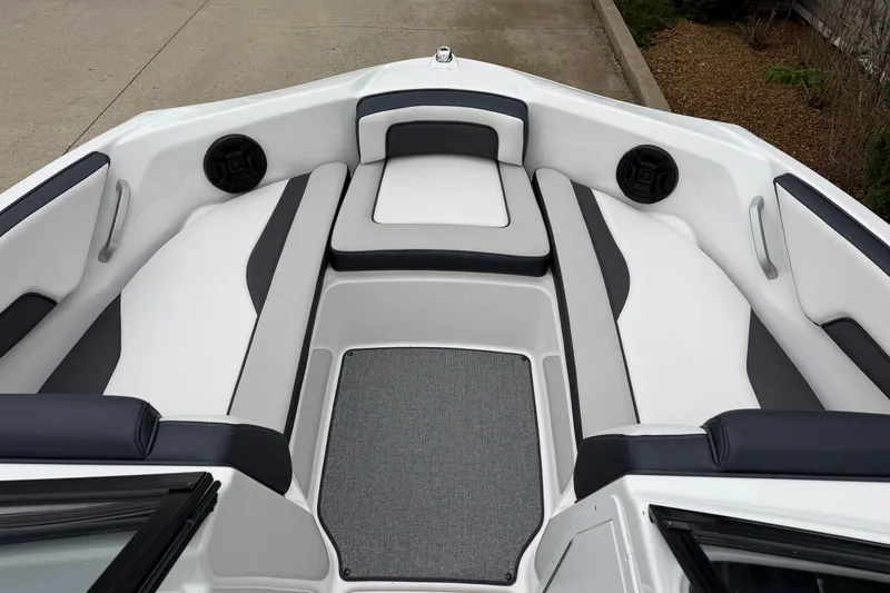 Slide: The Image of 2019 Yamaha Boats SX195 interior with white and black seating, speakers, and carpeted floor. - 13