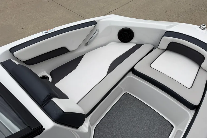 Slide: The Image of 2019 Yamaha Boats SX195 interior with sleek white and black seating design. - 15