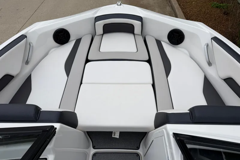 Slide: The Image of 2019 Yamaha Boats SX195 interior with white and gray seating, featuring built-in speakers. - 18