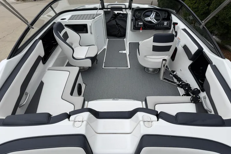 Slide: The Image of 2019 Yamaha Boats SX195 interior with sleek seating and modern dashboard design. - 4