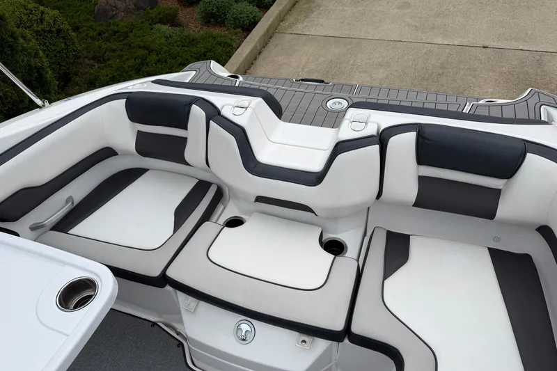 Slide: The Image of 2019 Yamaha Boats SX195 interior seating with sleek white and black upholstery design. - 6