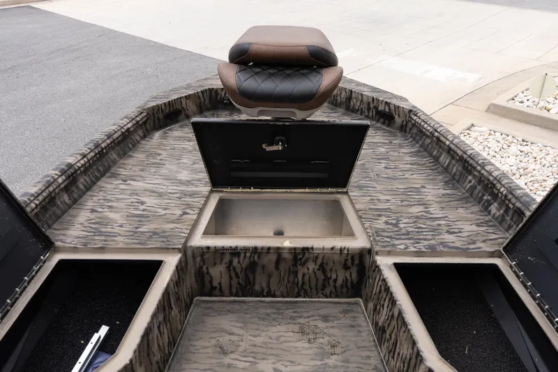Slide: The Image of 2026 Excel 203 Bay Pro Elite boat interior with storage compartments and seating. - 10