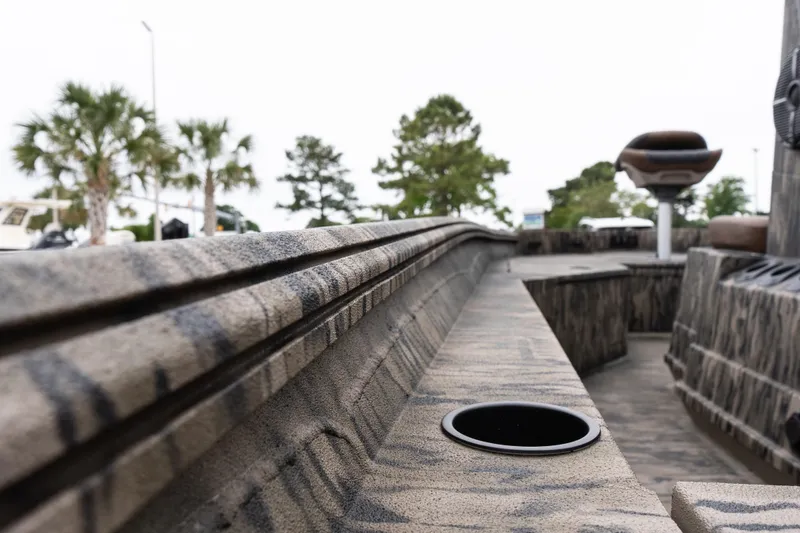 Slide: The Image of 2026 Excel 203 Bay Pro Elite boat interior with camouflage design and cup holder. - 13