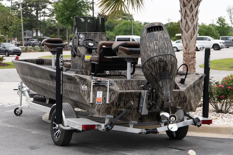 Slide: The Image of 2026 Excel 203 Bay Pro Elite boat on trailer, parked outdoors. - 4