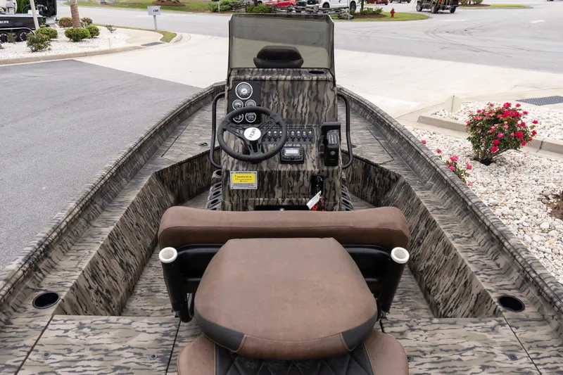 Slide: The Image of 2026 Excel 203 Bay Pro Elite boat interior with camouflage design and steering console. - 7