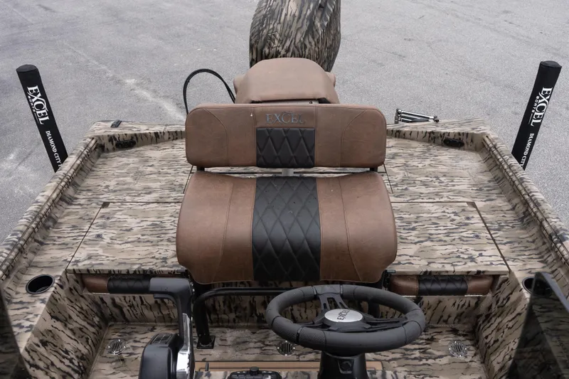 Slide: The Image of 2026 Excel 203 Bay Pro Elite boat interior with camo design and brown seating. - 8