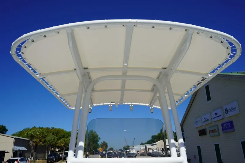 Slide: The Image of 2026 Robalo R202 Explorer boat canopy against clear blue sky. - 12