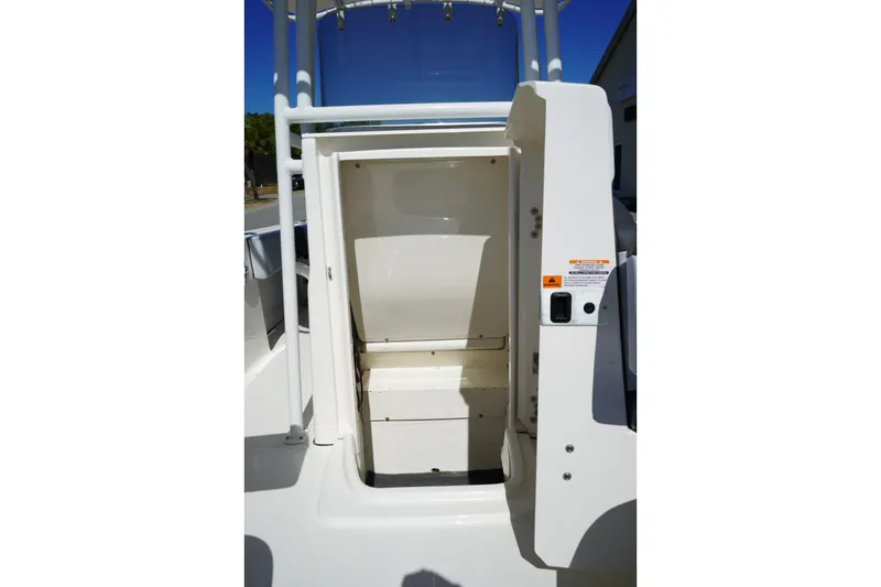 Slide: The Image of 2026 Robalo R202 Explorer boat storage compartment with open hatch. - 18
