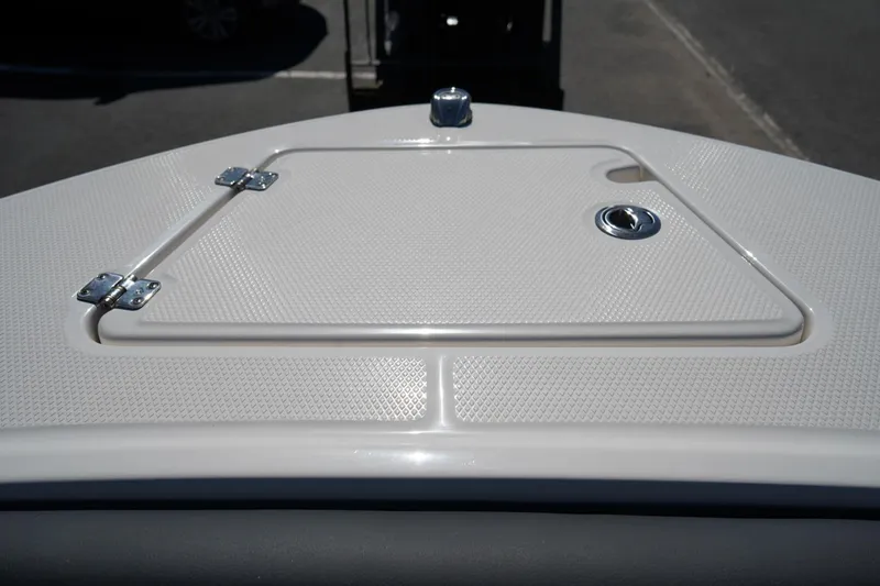 Slide: The Image of 2026 Robalo R202 Explorer boat hatch with textured surface and metal hinges. - 19