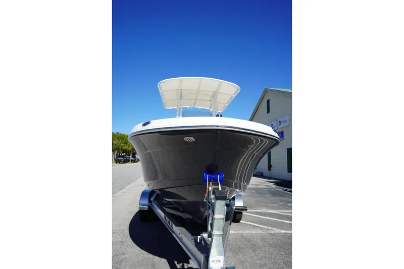Slide: The Image of 2026 Robalo R202 Explorer boat on trailer under clear blue sky. - 2