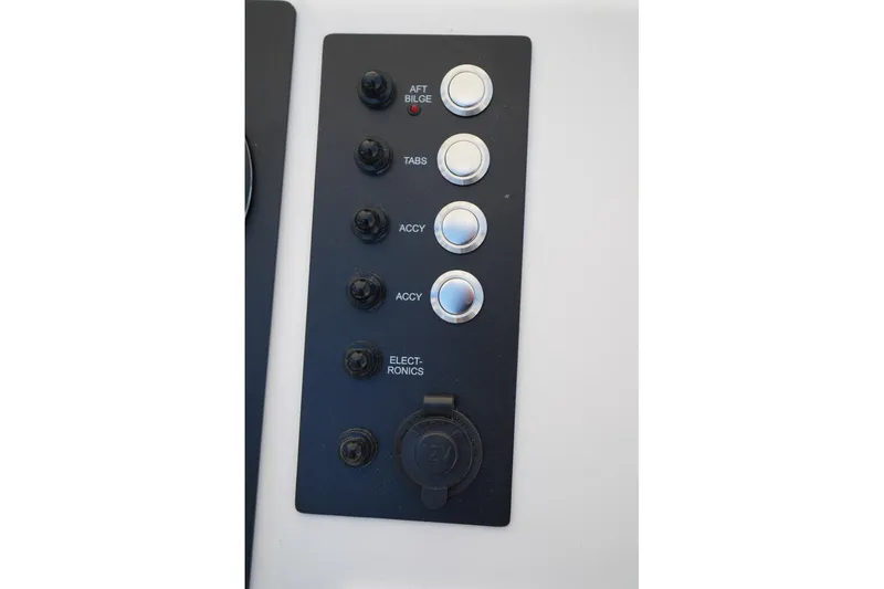Slide: The Image of Control panel of 2026 Robalo R202 Explorer boat with labeled switches and buttons. - 7