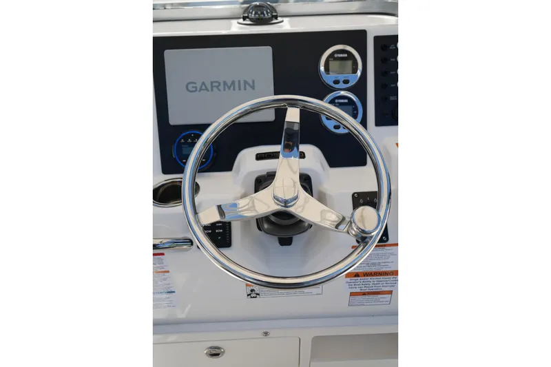 Slide: The Image of Steering wheel and dashboard of 2026 Robalo R202 Explorer boat with Garmin display. - 8